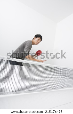 Table tennis player preparing to serve