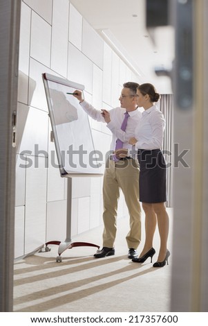 Business colleagues preparing for presentation in office