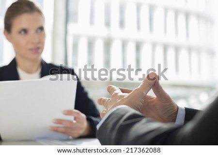 Cropped image of businessman in meeting with colleague at office cafe