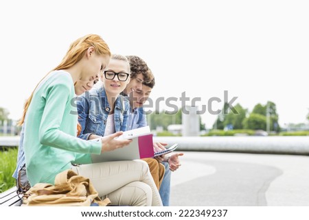 University students studying together at park