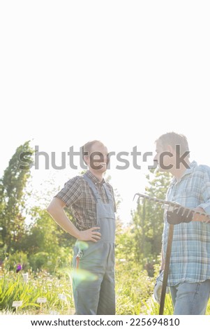 Happy gardeners conversing at plant nursery