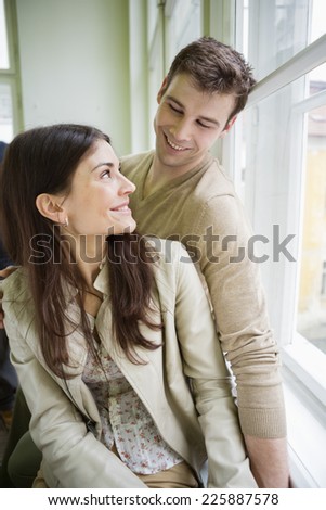 Happy romantic couple looking at each other at home