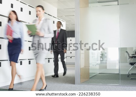 Blurred view of businesswomen walking in office