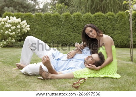 Full length of young man lying on woman\'s lap in park