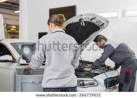 Automobile mechanics working in automobile repair shop
