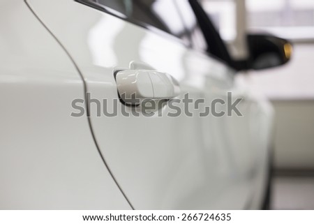 Close-up of white car in repair store