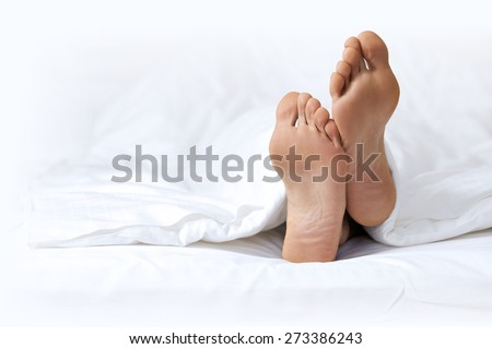 Person\'s foot in bed