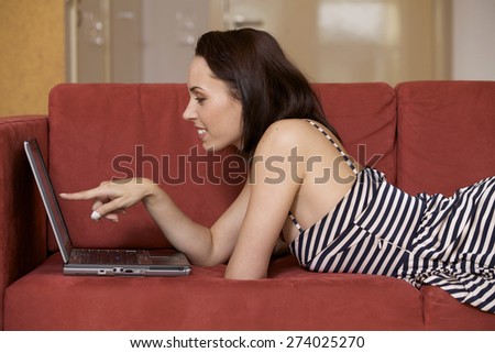 Young woman pointing at laptop