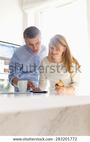 Father and daughter using tablet PC at home