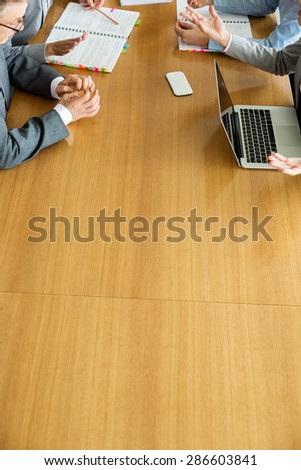 Cropped image of businesspeople discussing at conference table