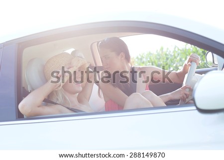 Happy female friends enjoying road trip