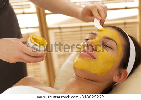 Close-up of young woman having facial mask in beauty parlor