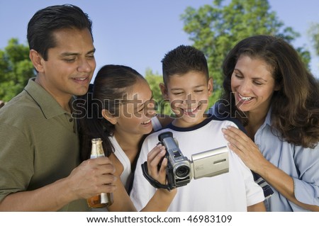 Family Watching Video Camera