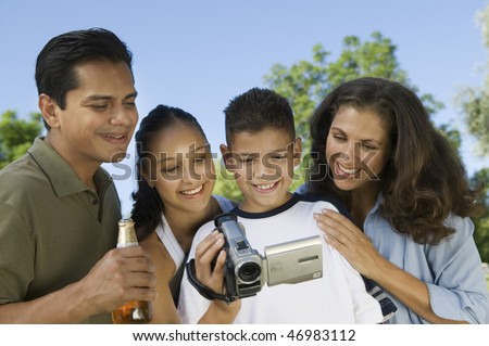 Family Watching Video Camera