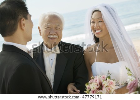 Asian Bride and Groom With Father