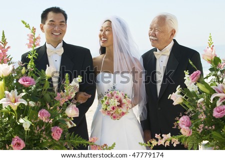 Asian Bride and Groom With Father