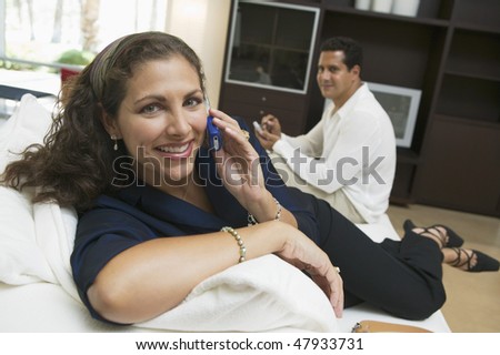 Woman Using Cell Phone on Sofa
