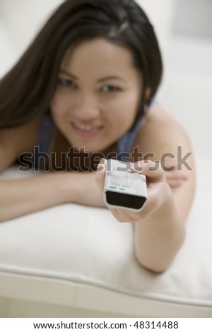 Young Woman on Couch with Remote Control
