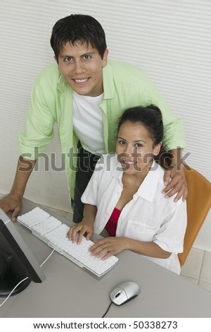 Couple at desk Using Computer, portrait, high angle view