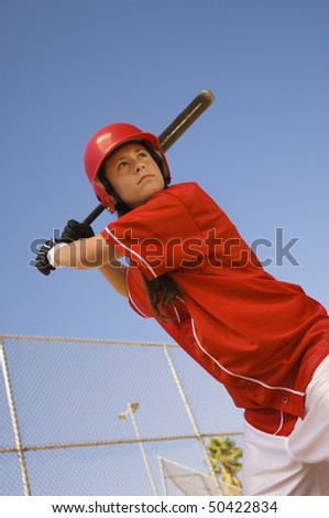 Softball player at bat, portrait, low angle view
