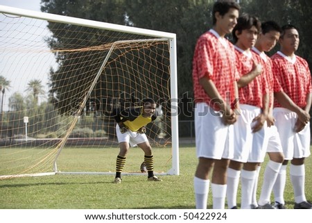 Soccer players preparing for free kick