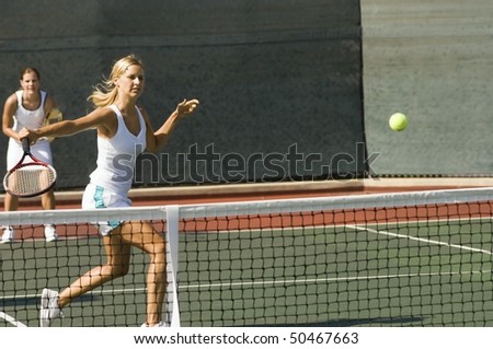 stock photo : Doubles tennis Player Hitting tennis ball with Backhand