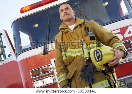 Fire fighter standing in front of fire engine