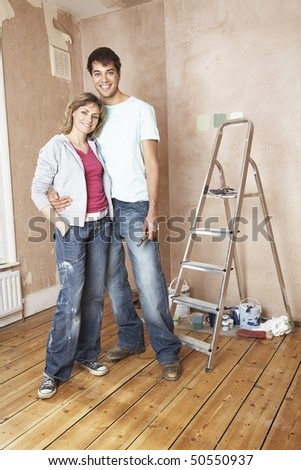 Couple embracing in unrenovated living room