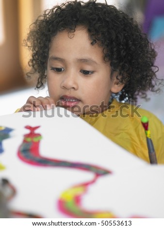 Girl looking at painting in art class