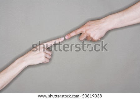 Man and woman almost touching extended index fingers, close-up on arms