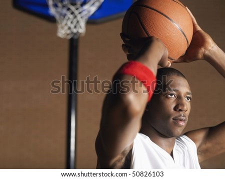 Basketball player preparing to throw ball, portrait