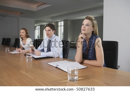 Three businesspeople sitting at conference table