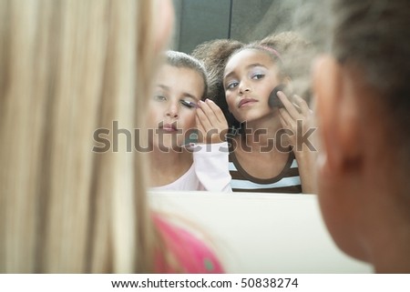 looking in mirror. stock photo : Girls looking in