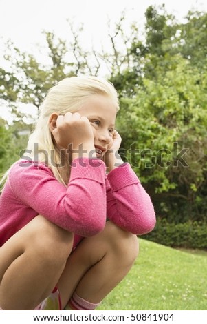 Girl Sitting with Head in Hands