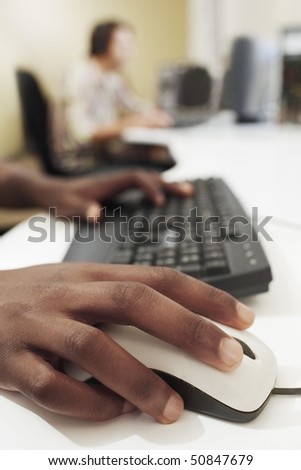 Man using keyboard and mouse, close-up.