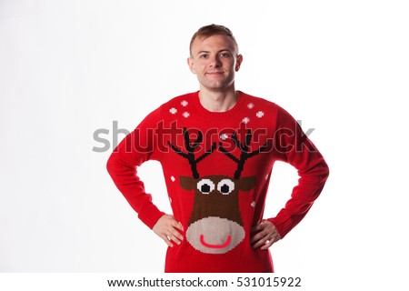 Caucasian man with hand on hips whilst wearing a christmas jumper