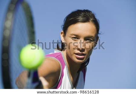Tennis Player Hitting Ball