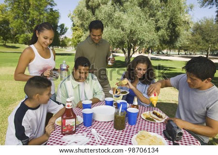 Family Gathered Around Picnic Table