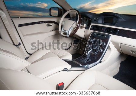 Modern car interior with sunset in the windows