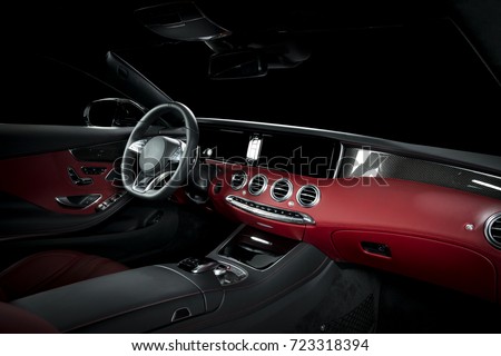 Red luxury car Interior - steering wheel, shift lever and dashboard. Clipping path for windows included