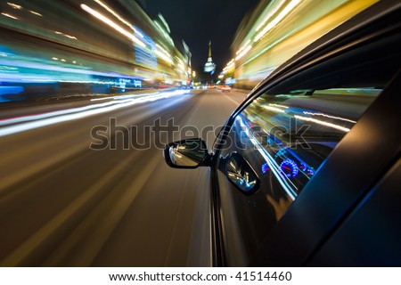 stock photo Car driving fast in the night city