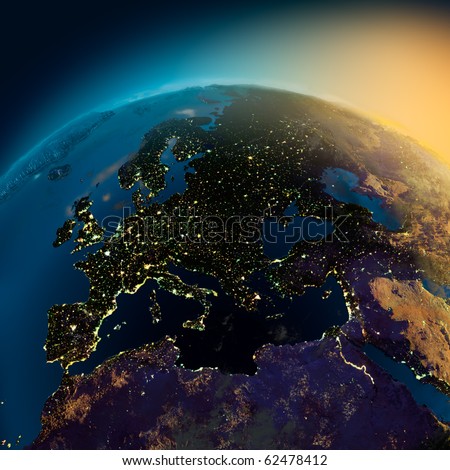 Night view of Europe from the satellite to the glowing lights of towns on the sunrise from the east