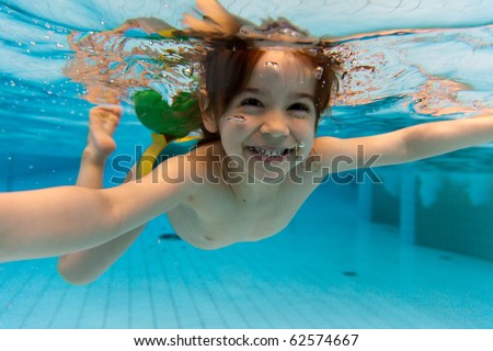 stock photo The little girl in the water park swimming underwater and 