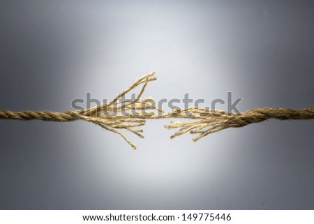 Broken rope on dark background.