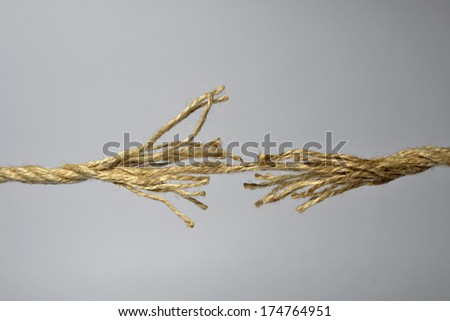 Broken rope on the gray background.
