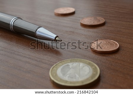 Financial background with money, table and pen.