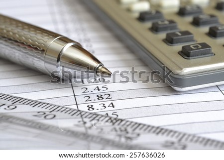 Business background with table, ruler, pen and calculator.