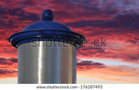Blank advertising column in front of sky with sun rise
