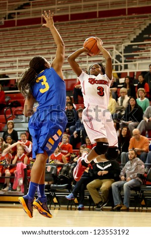 JAMAICA, NY-JAN 2: St. John\'s Red Storm guard Aliyyah Handford (3) shoots over Delaware Blue Hens guard Jaquetta May (3) at Carnesecca Arena on January 2, 2013 in Jamaica, Queens, New York.