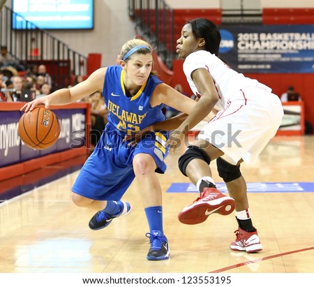 JAMAICA, NY-JAN 2: Delaware Blue Hens guard Lauren Carra (22) dribbles around St. John's Red Storm at Carnesecca Arena on January 2, 2013 in Jamaica, Queens, New York.
